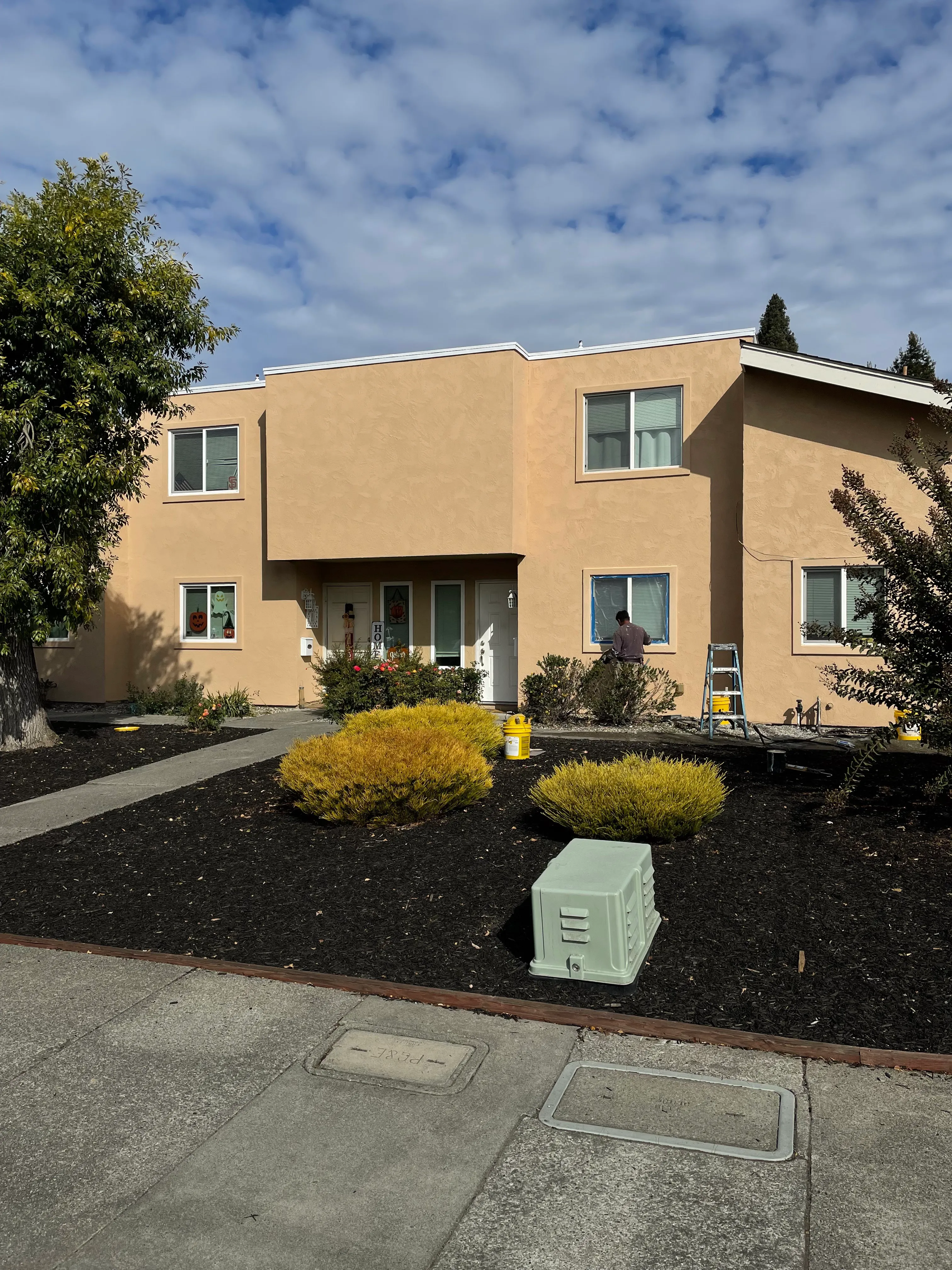 New stucco facade with clean trim lines around windows (after) — siding-to-stucco conversion