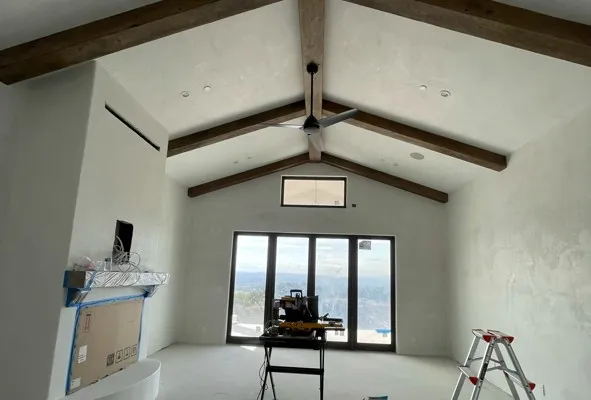 Vaulted great room with smooth venetian plaster walls and exposed wood beams — interior plaster in Santa Rosa