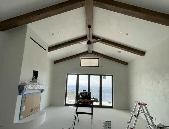 Vaulted great room with smooth venetian plaster walls and exposed wood beams — interior plaster in Santa Rosa